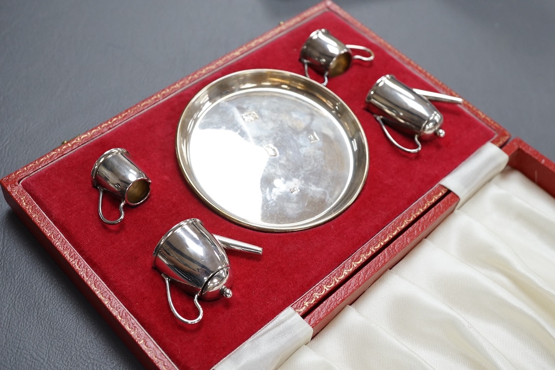 An Elizabeth II cased silver miniature silver four piece tea and coffee set and tray, by Bishton's Ltd, Birmingham, 1977/8, together with an earlier cased silver three piece condiment set.
